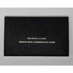 the official olympic precious metal commemorative black album with the 1 and 2